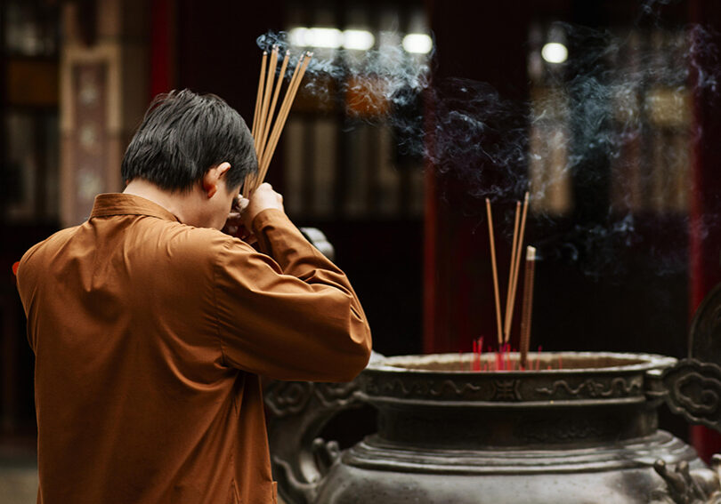 side-view-religious-man-temple-with-burning-incense-copy-space